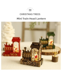Close-up of retro Christmas train lantern with Santa Claus and sparkling liquid glitter