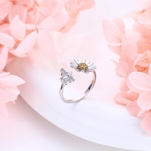Macro shot of S925 sterling silver sunflower and bee ring detail with yellow zircon