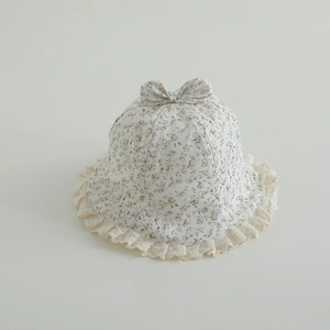 Detail of floral baby sun hat with delicate lace trim and ribbon bow decoration