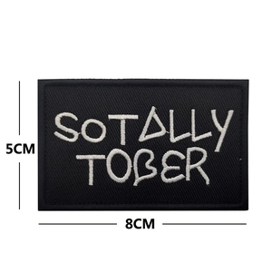 Detail showing embroidered 8x5cm black patch with SOTALLY TOBER white lettering