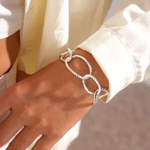 Detail of silver chain bracelet with hammered texture on wrist for a modern industrial look
