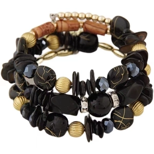 Multilayer bohemian beaded bracelet featuring black stones, golden metal and wood beads