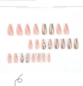 Coffin shaped press-on nails with marble patterns, gold glitter and pink french tip design