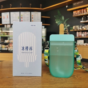 Detail view of 300ml mint green popsicle water bottle with adjustable colorful strap