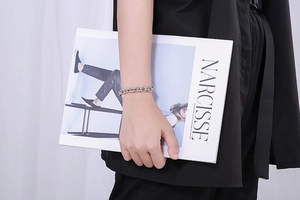 Polished silver stainless steel OT toggle chain bracelet worn by a model on a wrist