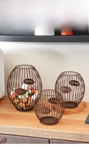Close-up of three bronze wire coffee capsule baskets with COFFEE metal labels