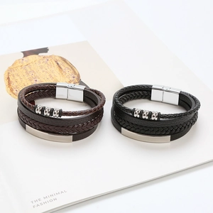 Detail of multi-layer woven leather bracelets with metal beads and magnetic clasps
