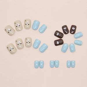 Close-up of cute bear and polka dot patterns on glossy short press-on nails set
