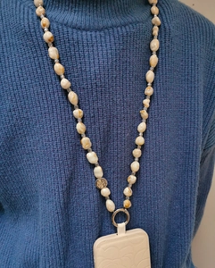 Detail of long bohemian phone strap with marble resin beads and silver floral spacers