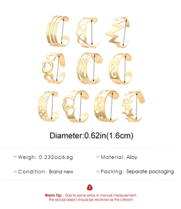 Detailed view of 10-piece gold alloy toe ring set with heart and star patterns