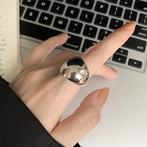 Close-up of polished 925 sterling silver minimalist ring worn over a laptop keyboard