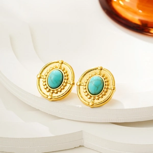 Macro shot of vintage oval turquoise stud earrings with radial texture in 18K gold finish