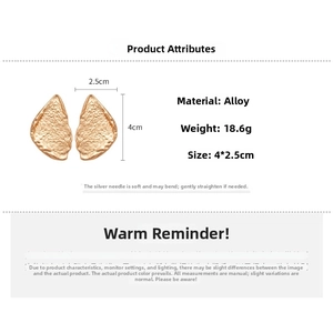 Detail view of gold triangle earrings with measurements and leaf-like metal texture