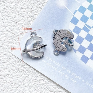 Detailed macro view of silver moon planet pendant with dimensions 14mm by 16mm