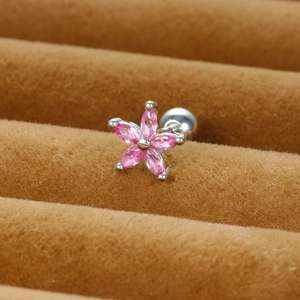 Macro shot of pink floral stud earrings with marquise zirconia on brown velvet