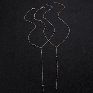 Close-up of double-layer Y-necklaces with bead details in gold and silver finish