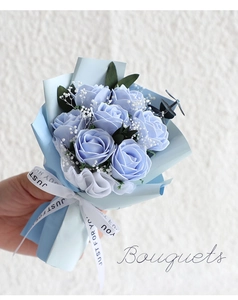 Detail of handmade blue soap flower bouquet with roses and ribbon for birthday gifts