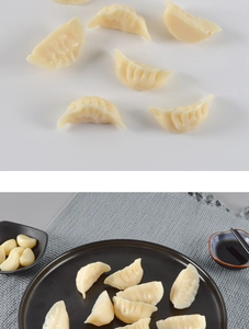 Close-up of realistic PVC dumpling models served on a black plate with soy sauce