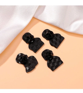 Set of four black metal pins featuring secure butterfly clasps and textured alloy backing