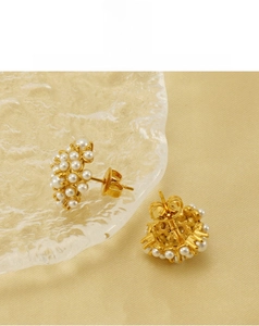 Detailed view of 18k gold pearl cluster earrings featuring multiple white pearls