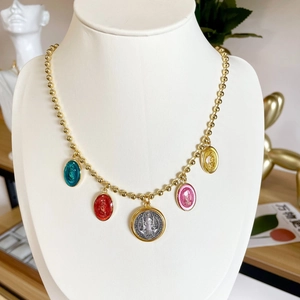 Gold beaded necklace with colorful enamel religious pendants and Virgin Mary medallion
