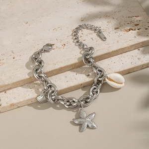 Detailed macro shot of silver stainless steel chain with starfish and natural seashell charm