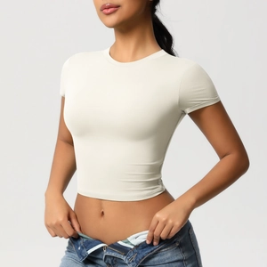 Close-up of cream short sleeve slim fit crop top with stretchy athletic fabric texture