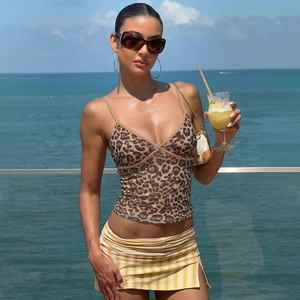 Detail of a sexy leopard print V-neck camisole top paired with a yellow striped mini skirt