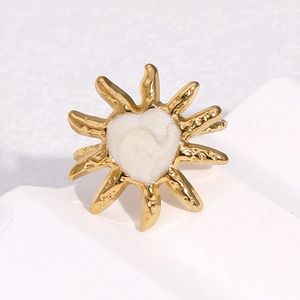 18k gold plated sunburst open ring with white enamel heart on textured stone base