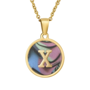 Detailed macro view of 18K gold plated necklace pendant with letter X and colorful shell inlay