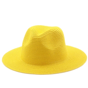 Detail view of tight weave texture and crown shape on a bright yellow straw Panama hat