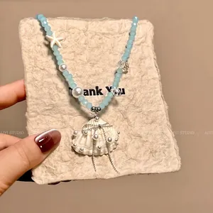 Blue beaded sea shell necklace with white starfish and pearl pendant for beach vacation