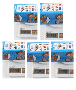 Detailed view of various stacking game toy sets on digital scales showing total package weight