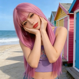 Long straight pink wig with air bangs on a model at a beach with colorful huts