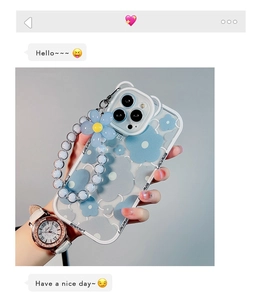Detail of blue floral iPhone case with matching beaded wrist strap and 3D flower charm