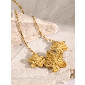 18k gold plated stainless steel necklace with three textured floral charms on a stone