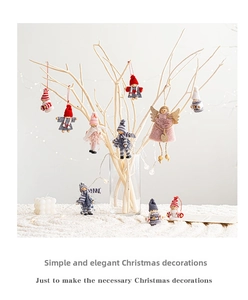 Detailed view of handmade Christmas plush hanging ornaments on white branch decor