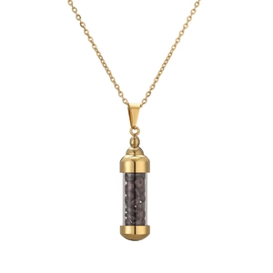 Close-up of gold stainless steel perfume bottle necklace with red crystal stones inside