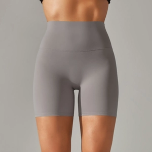 Detail view of high-waist yoga shorts with seamless waistband in dark grey matte fabric