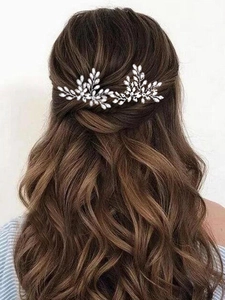Silver bridal hair pins with leaf shape and crystals on model brown wavy hair