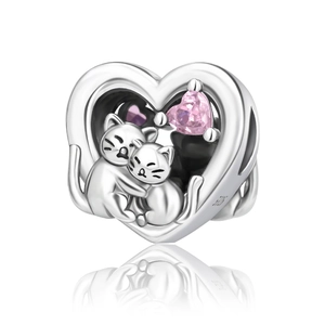 Detail of silver heart charm with two cats and a pink gemstone inlay, S925 engraved