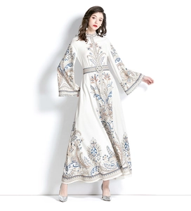 Detail of vintage ivory maxi dress featuring ethnic blue print and flared sleeves