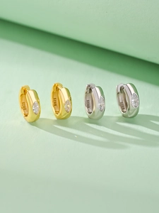 Macro detail of S925 sterling silver hoop earrings with marquise-cut zircon stones