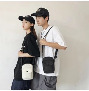 Close-up of minimalist canvas crossbody bags in black and beige worn by models