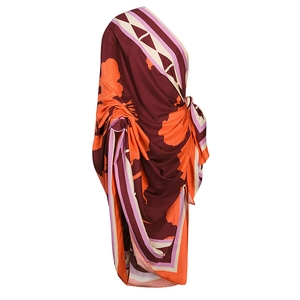 Detail of burgundy and orange floral print on a silk-like beach cover-up fabric