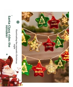 Close-up of star-shaped Christmas LED string lights with festive patterns and holiday prints
