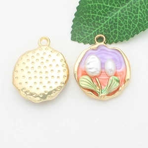 Detailed view of high-quality gold tulip charms with pearl accents on a white background