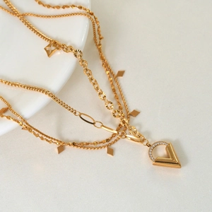 Gold layered stainless steel necklace featuring a V pendant with cubic zirconia inlay