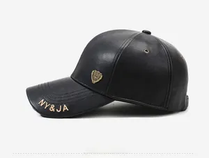 Detailed view of black leather baseball cap with gold shield emblem and NY&JA embroidery