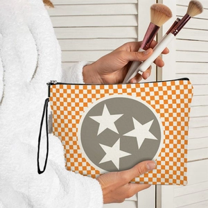 Star pattern checkered cosmetic bag with orange and white grid and zipper closure